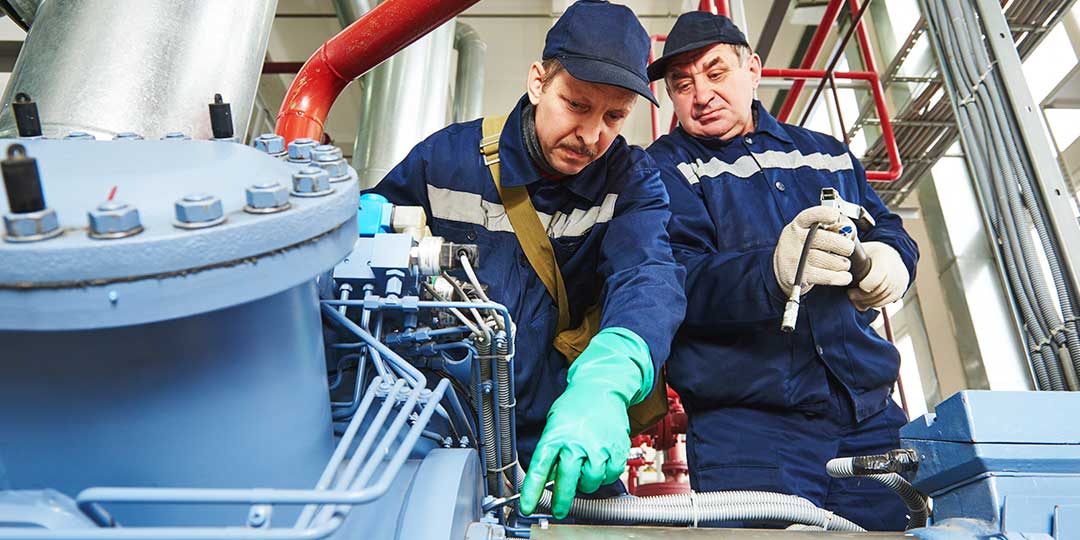 service workers at industrial compressor station